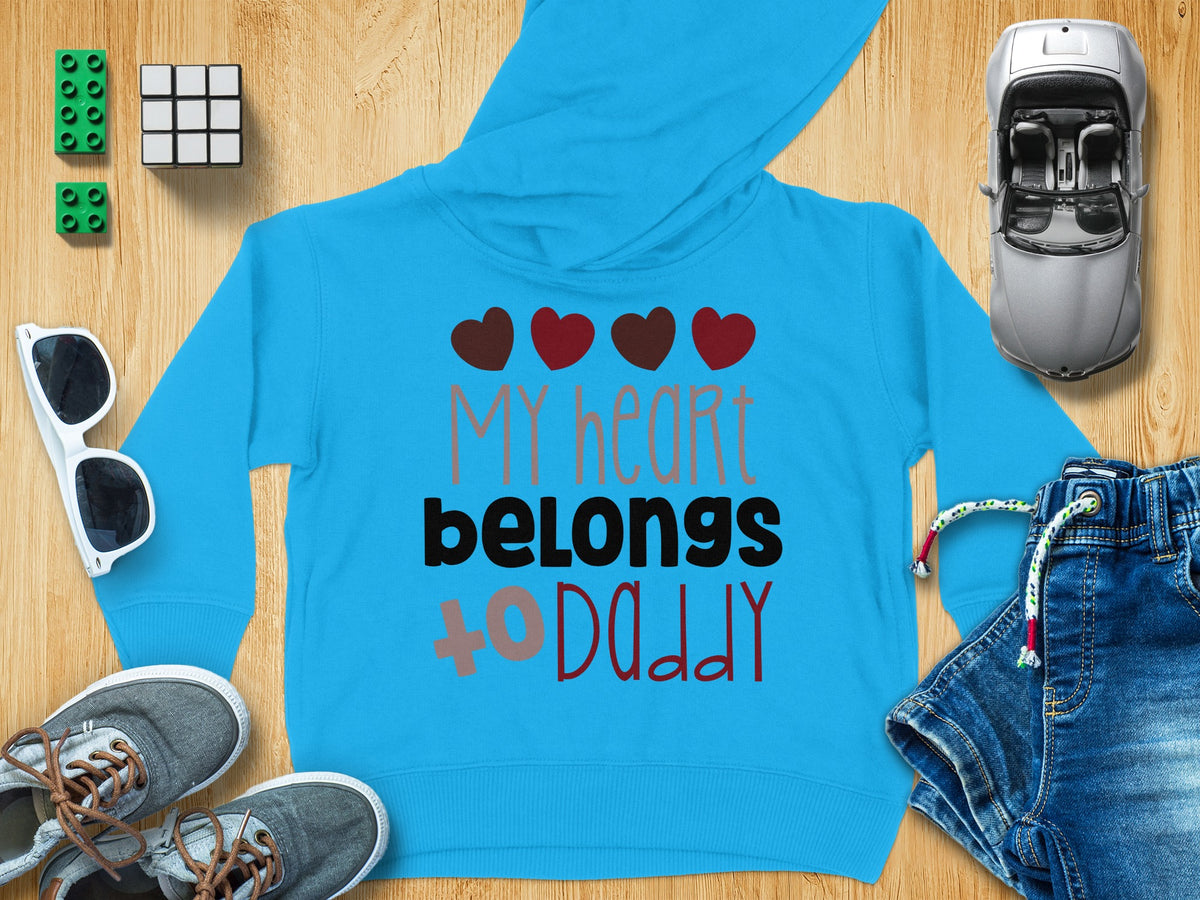 Bright blue children's hoodie featuring the text My heart belongs to Daddy surrounded by toys and clothes.