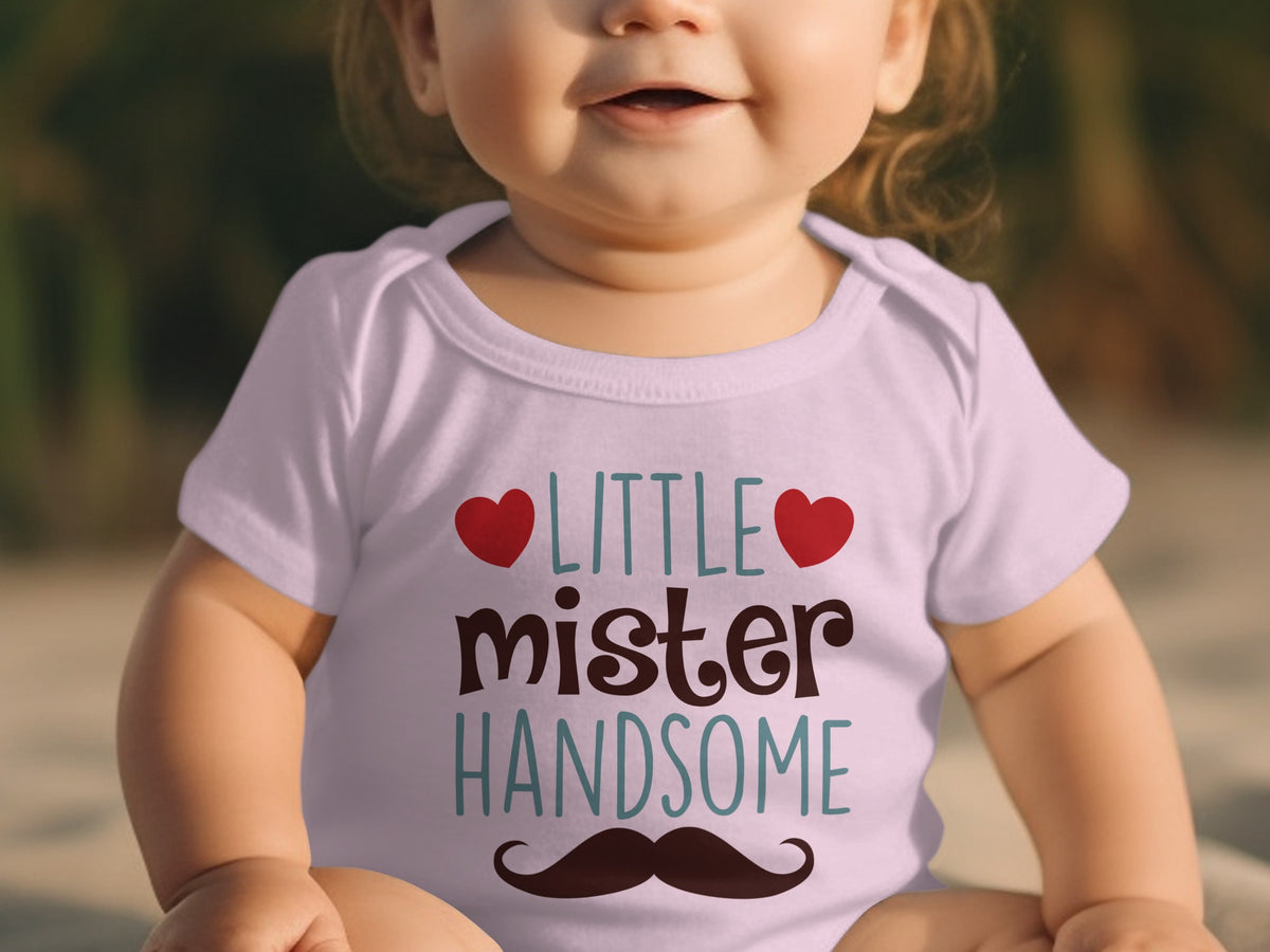 A baby wearing a light purple short-sleeved bodysuit with the text Little Mister Handsome and a mustache graphic.